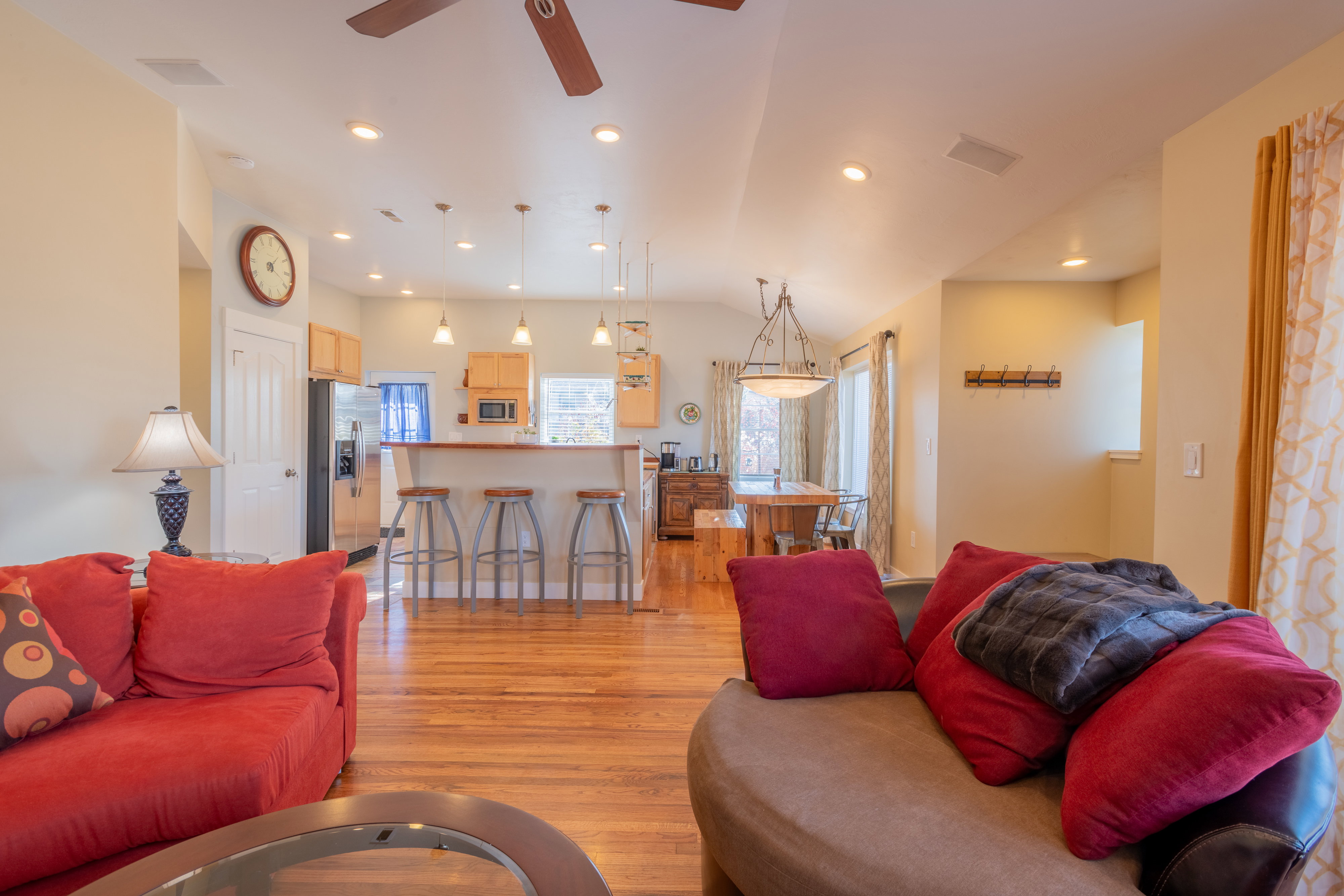 Living area with lofted ceiling, light wood-type flooring, ceiling fan, and recessed lighting
