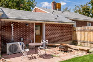 View of patio with a fire pit