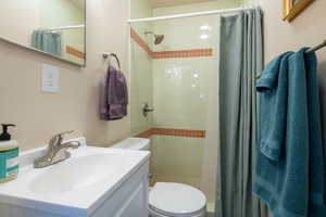 Full bathroom with vanity and a stall shower