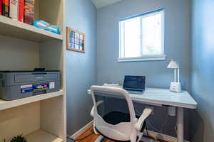 Office with baseboards and wood finished floors