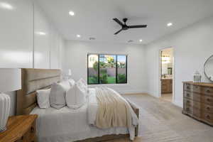 Bedroom with light carpet, ceiling fan, recessed lighting, and connected bathroom