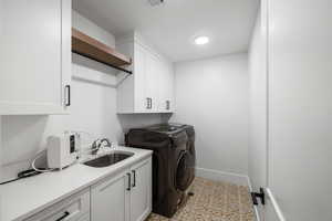 Laundry room featuring cabinet space and washer and dryer