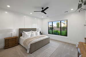 Bedroom with light carpet, ceiling fan, and recessed lighting