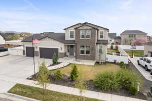 Craftsman-style home with a garage, brick siding, driveway, a residential view, and board and batten siding