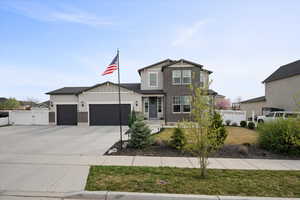 Craftsman house with a garage, brick siding, a gate, concrete driveway, and stucco siding