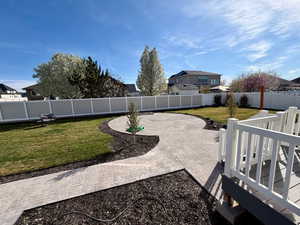 Fenced backyard featuring a patio area and a residential view