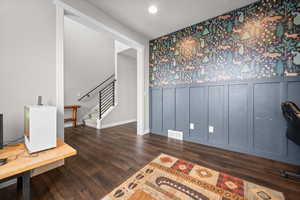 Office with wallpapered walls, dark wood finished floors, wainscoting, a decorative wall, and recessed lighting