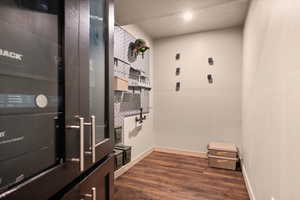 Mudroom featuring dark wood finished floors and baseboards