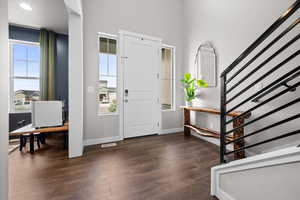 Entryway featuring stairway and dark wood finished floors