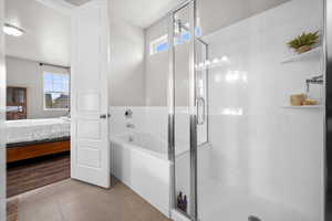 Ensuite bathroom with a bath, a stall shower, and tile patterned floors