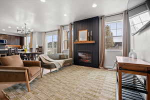Living area with a large fireplace and hanging lights