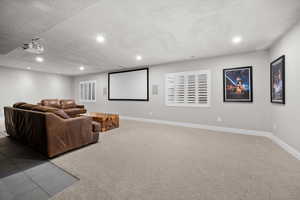 Cinema with light colored carpet, a textured ceiling, recessed lighting, and light tile patterned floors
