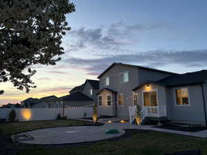 View of front of property with a patio area and stucco siding