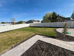 Fenced backyard with a patio area