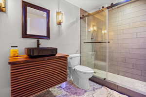 Bathroom featuring a stall shower and vanity