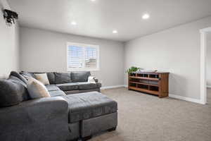 Living area featuring recessed lighting and light colored carpet