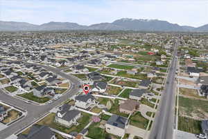 Aerial overview of property's location with nearby suburban area and a mountainous background