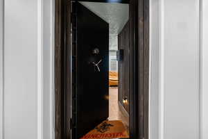 Hallway featuring a textured ceiling