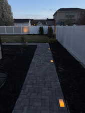 Yard at dusk featuring a fenced backyard