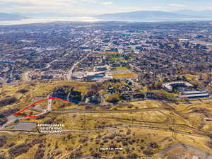 Aerial view of property and surrounding area with a mountainous background