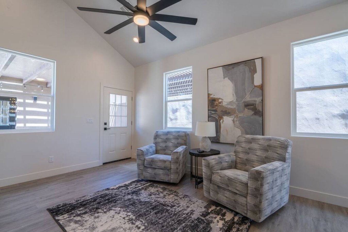 Sitting room with lofted ceiling, ceiling fan, wood finished floors, and recessed lighting