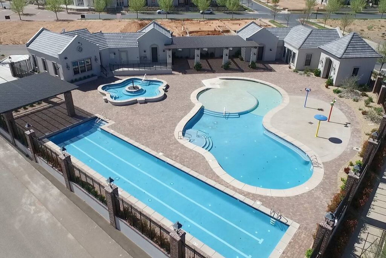 Community pool featuring a patio, a pergola, and a hot tub