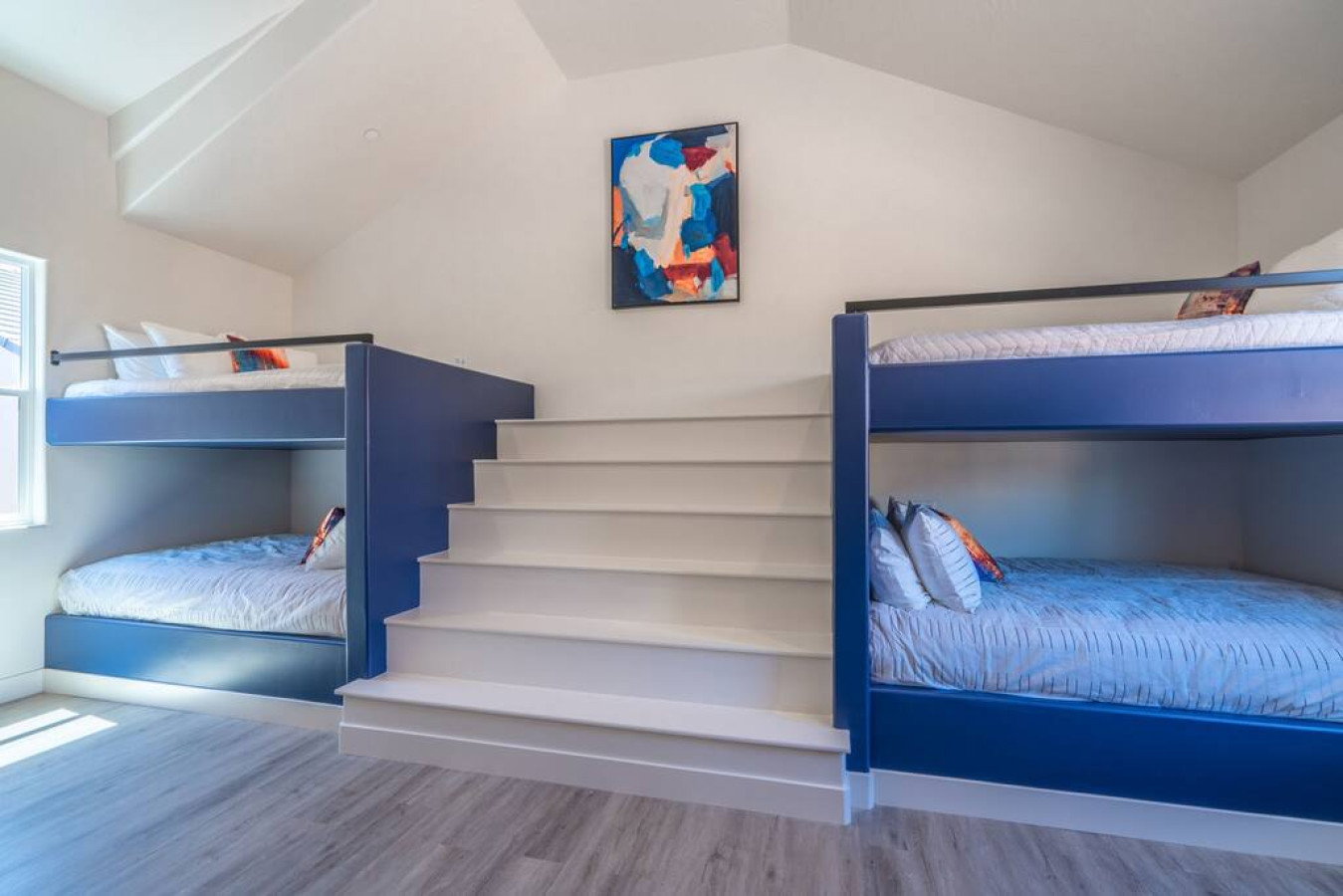 Bedroom featuring light wood-style floors and vaulted ceiling