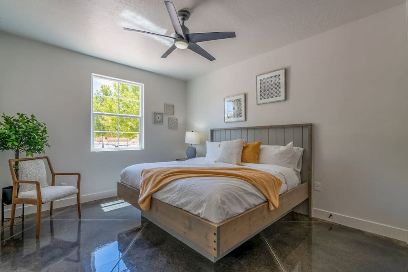 Bedroom featuring concrete floors and a ceiling fan