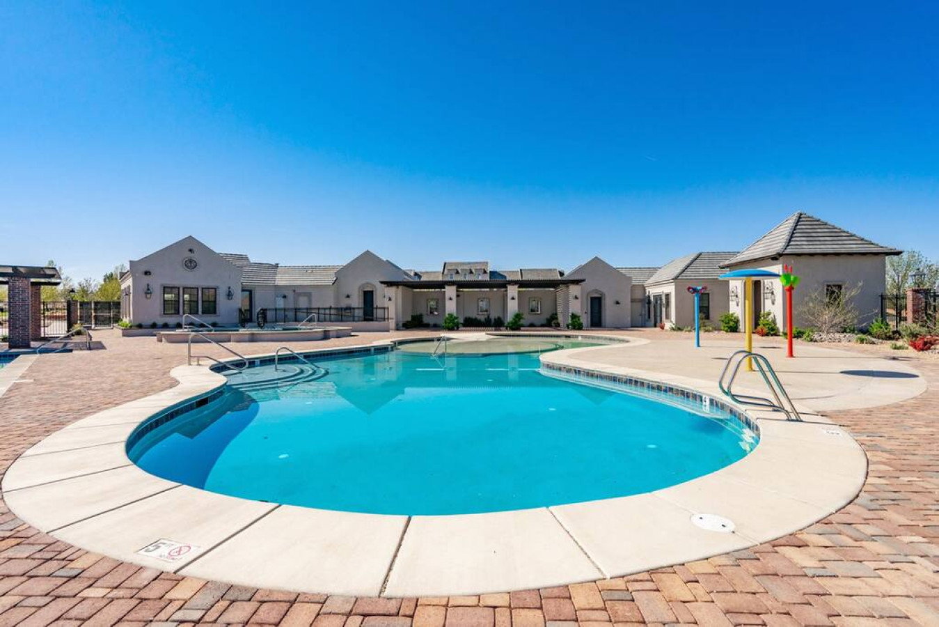 Community pool with a patio and a residential view