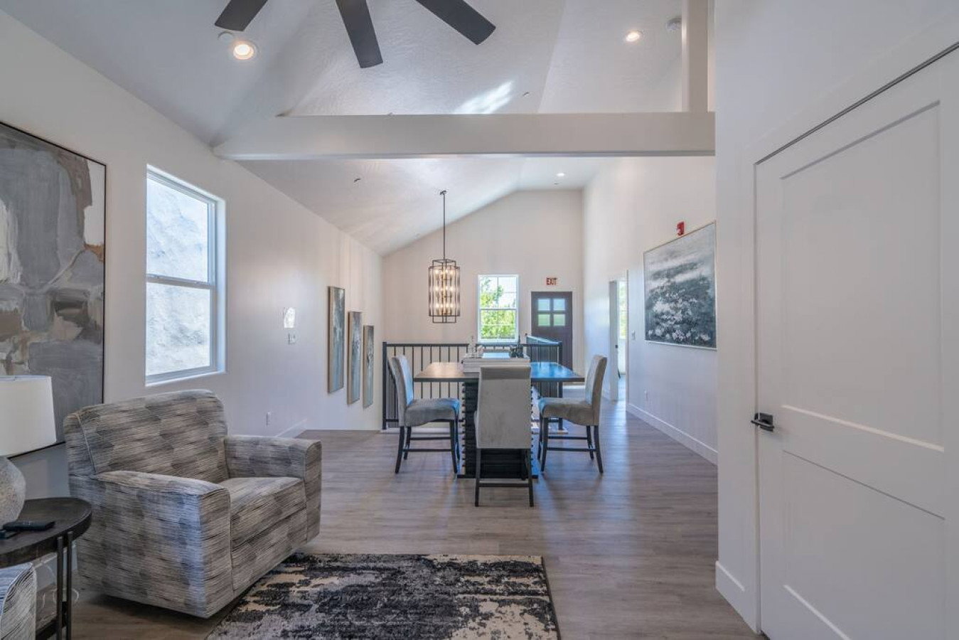 Dining space featuring light wood-type flooring, vaulted ceiling, ceiling fan, and recessed lighting