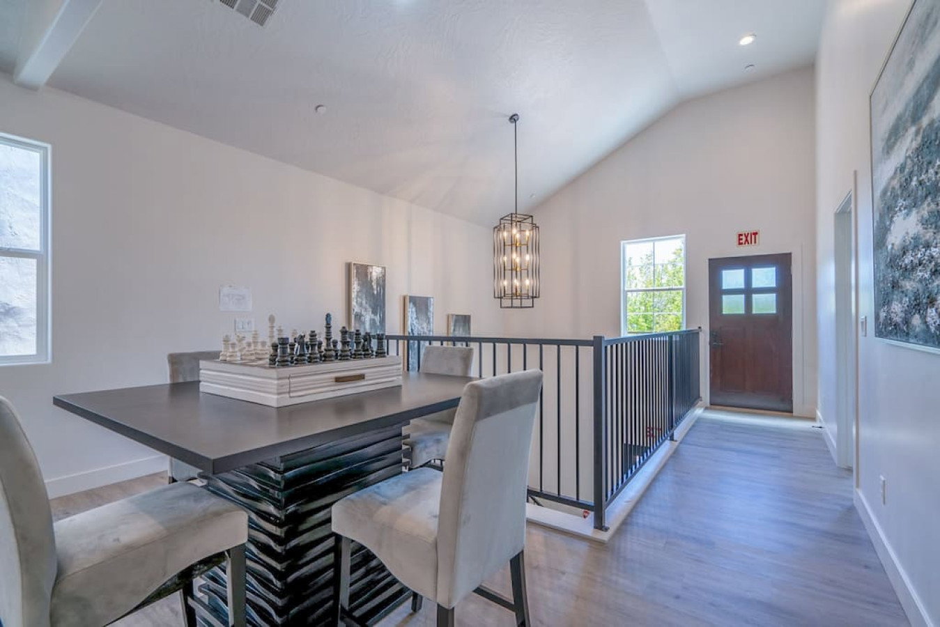 Dining area featuring light wood-type flooring, vaulted ceiling, and a chandelier