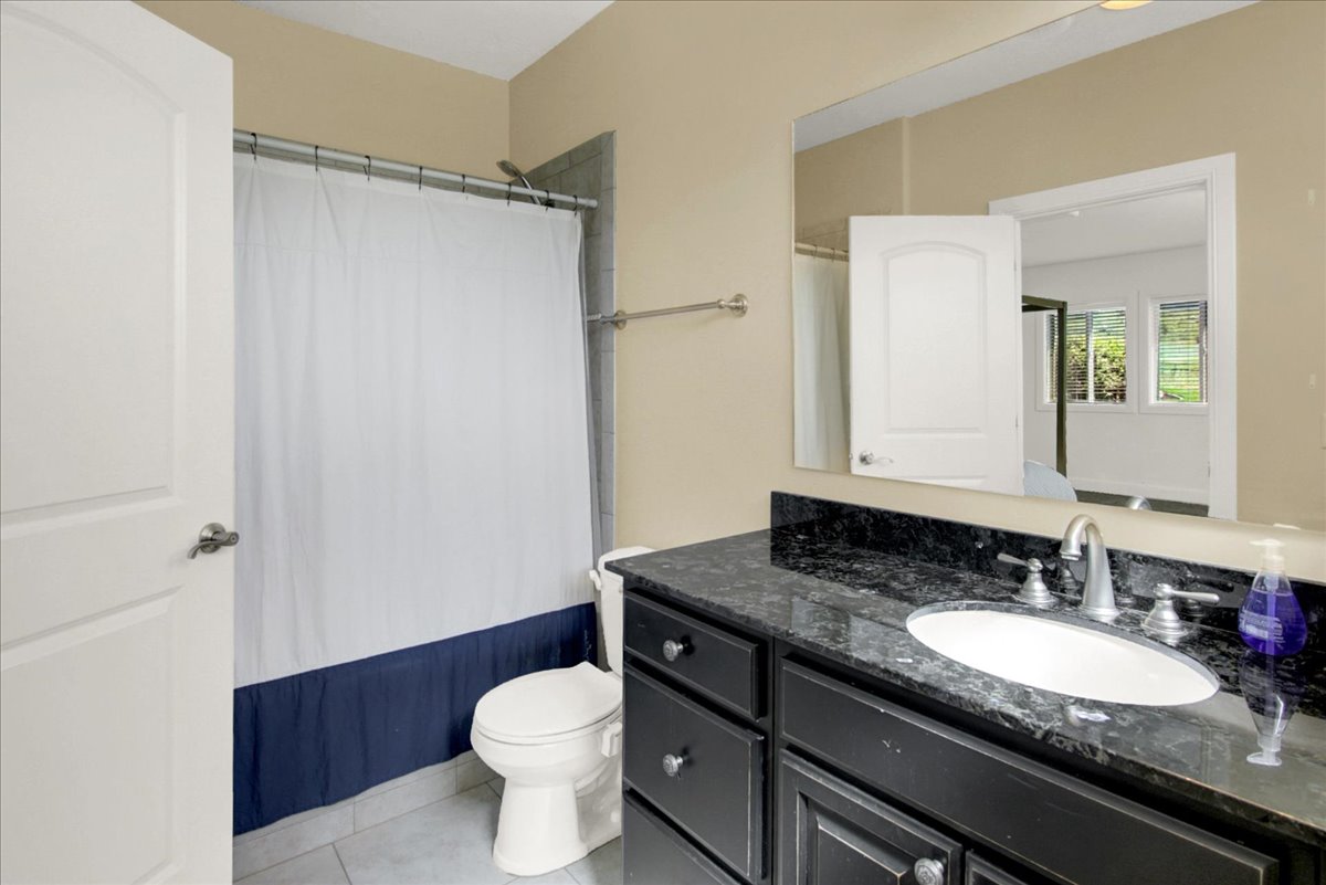 Basement South Bedroom Bathroom with vanity and light tile patterned floors