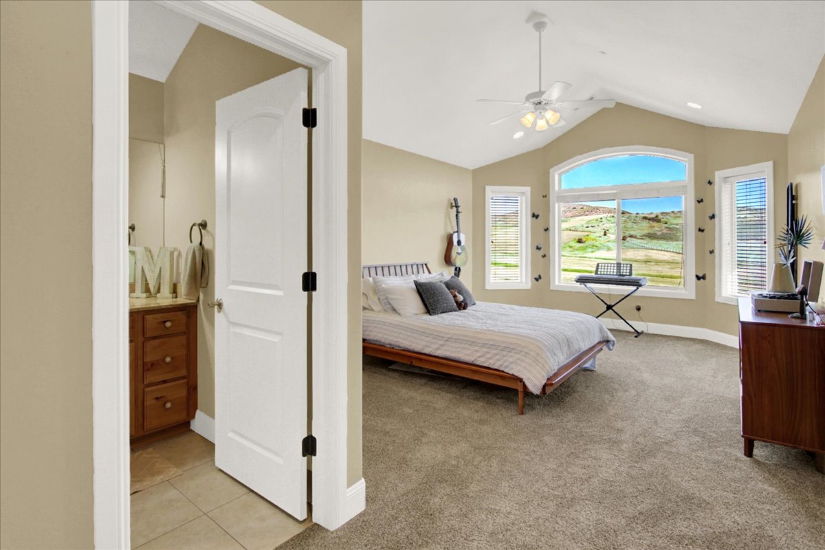 North Upstairs Bedroom with light carpet, ceiling fan, and light tile patterned flooring