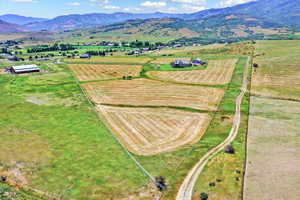View of rural area with a mountainous background and extensive farmland