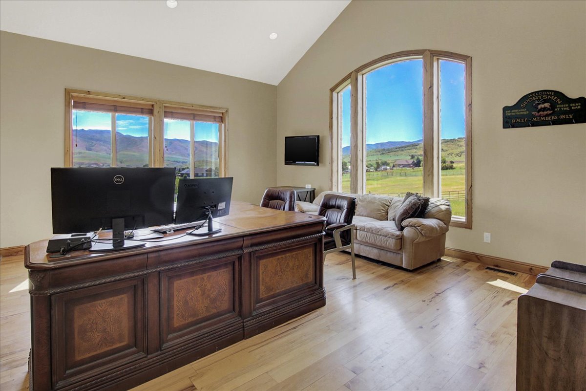 Main Office area featuring light wood-style floors and lofted ceiling
