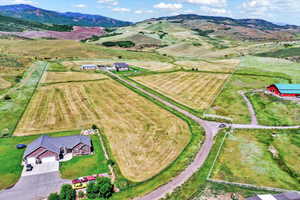Overview of rural landscape with a mountainous background and rows of crops