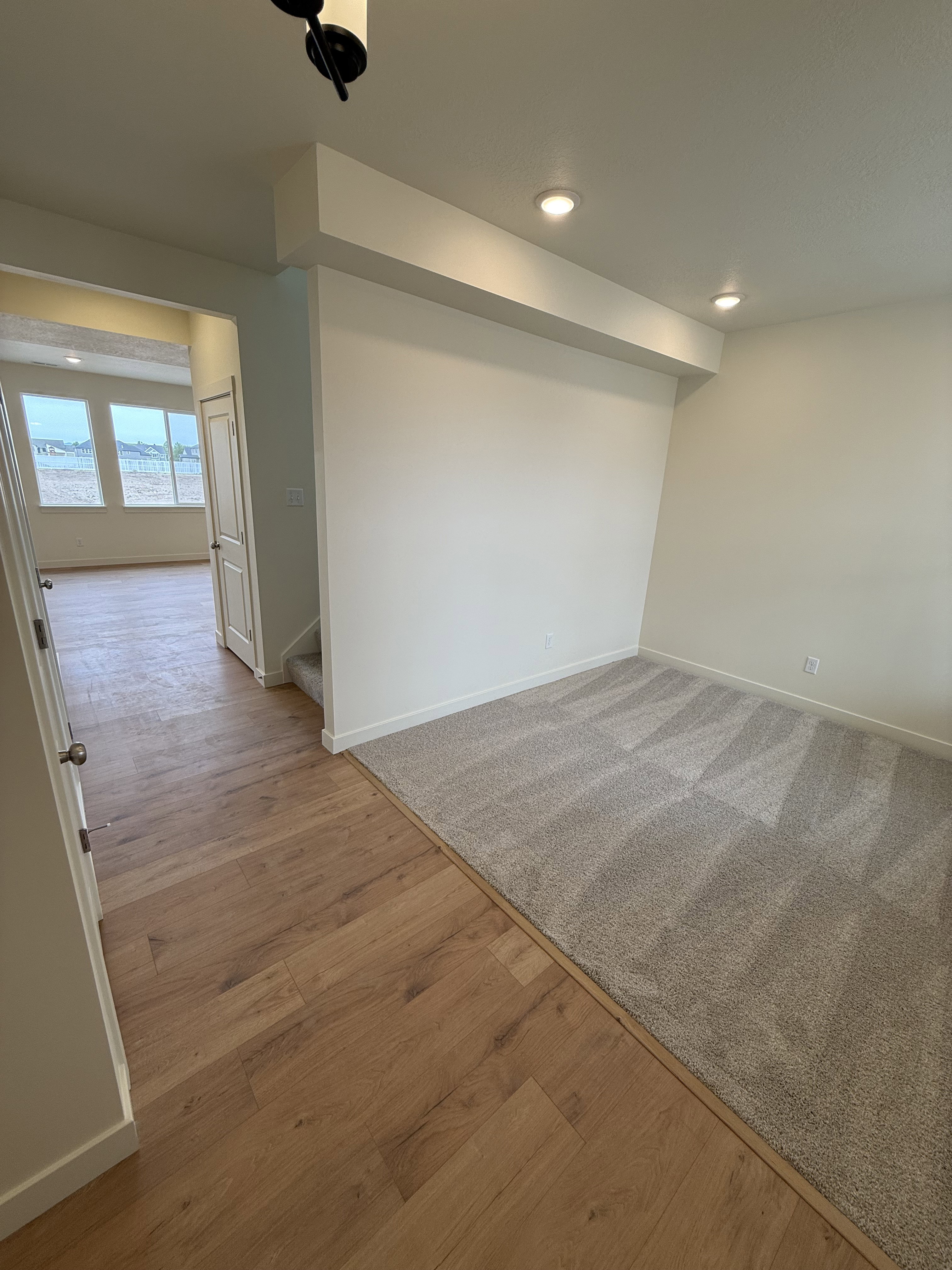 Interior space featuring recessed lighting, light wood-finish flooring, and light-toned carpeting