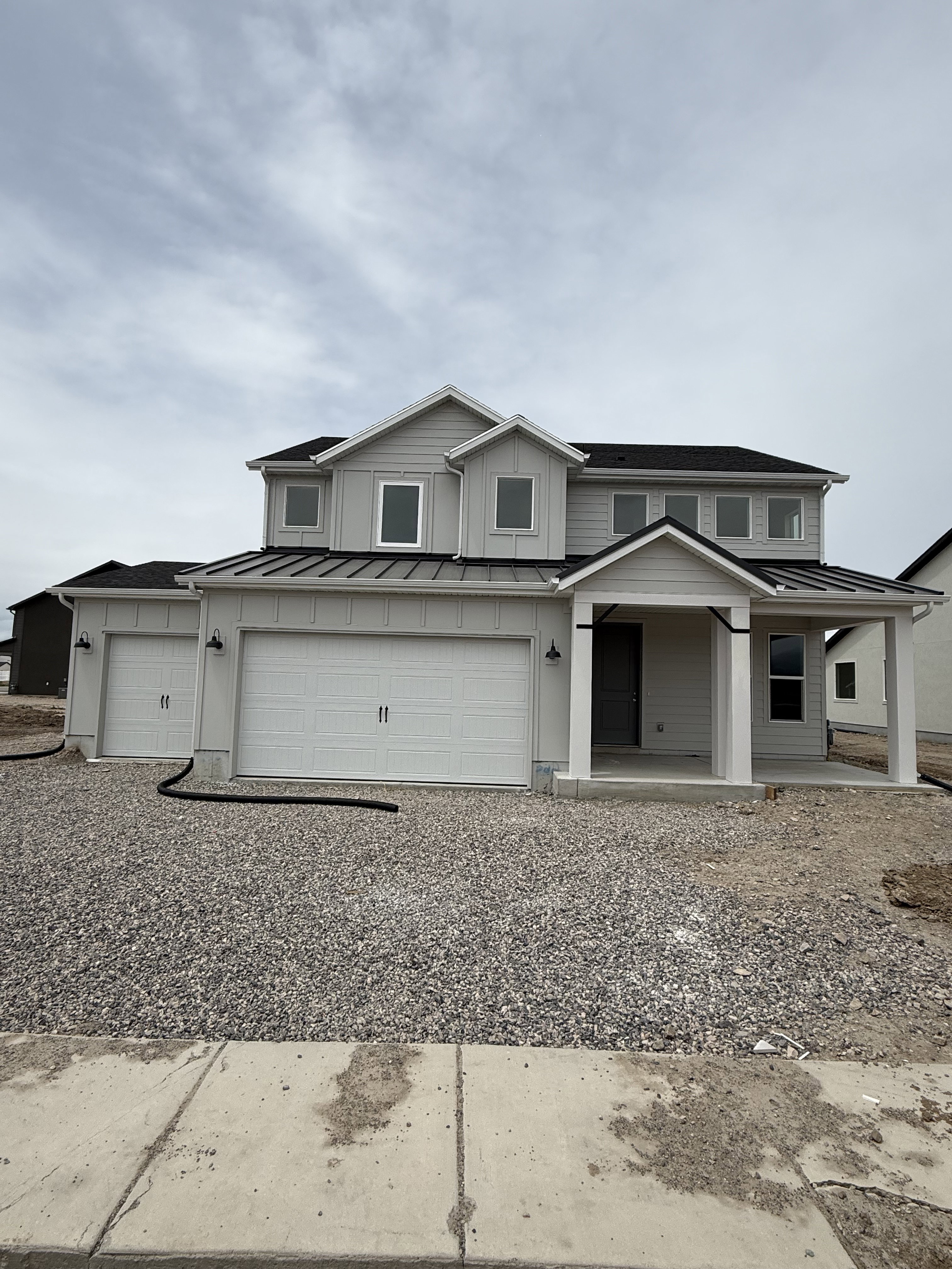 Contemporary two-story residence with a light gray siding exterior
