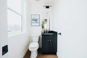 Half bath featuring vanity and light wood-style flooring