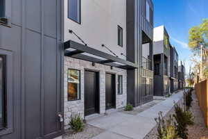 Doorway to property with stone siding and board and batten siding