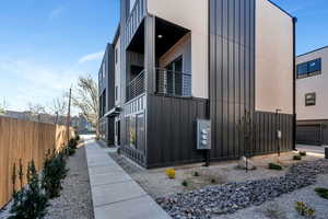 View of property exterior with board and batten siding and a balcony