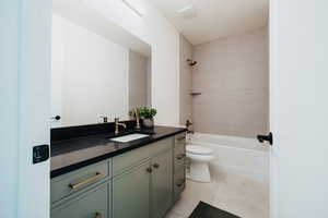 Full bathroom featuring vanity, shower / tub combination, and light tile patterned floors