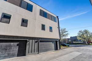 View of apartment building / complex featuring a garage