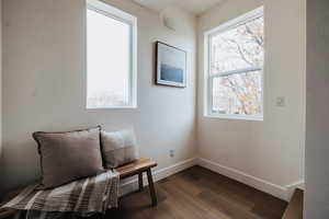 Sitting room with baseboards and dark wood-type flooring