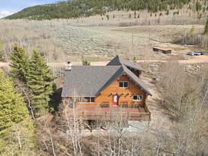View from above of property featuring a forest and mountains