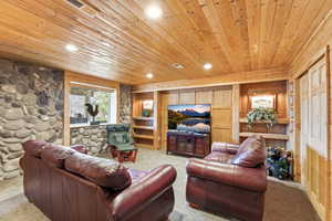 Living area featuring recessed lighting, wood ceiling, and light colored carpet