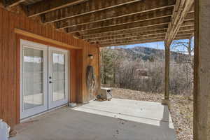 View of patio with french doors and a mountain view