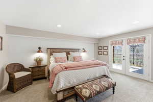 Bedroom with french doors, access to exterior, light carpet, and recessed lighting