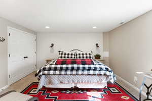 Bedroom with light carpet and recessed lighting