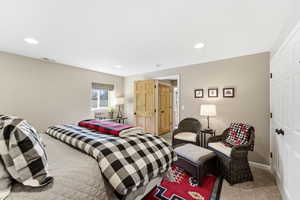 Bedroom with light carpet, a closet, and recessed lighting